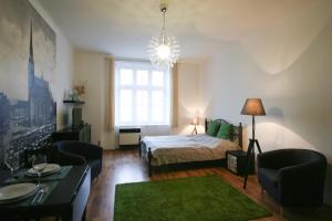 a bedroom with a bed and a green rug at Apartmán Mrakodrap in Pilsen