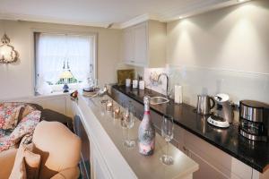 a kitchen with a counter with wine glasses on it at Sönshorn 8 Rechts in Munkmarsch