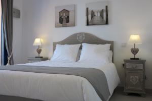 a bedroom with a large bed with white sheets and pillows at Penthouse "Art4you" in Mojácar +40 photos