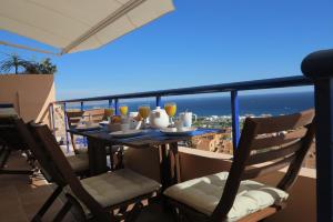 a table on a balcony with a view of the ocean at Penthouse "Art4you" in Mojácar