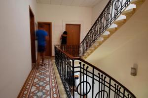 a man and a woman walking down a stairs at Corner Hostel in Sliema