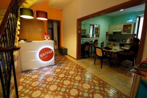 a kitchen and dining room with a tile floor at Corner Hostel in Sliema