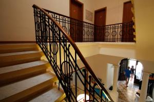 a person walking down a staircase in a building at Corner Hostel in Sliema