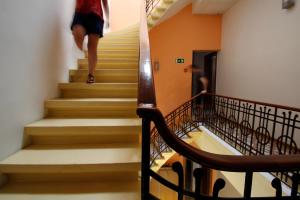 a person walking down stairs in a building at Corner Hostel in Sliema