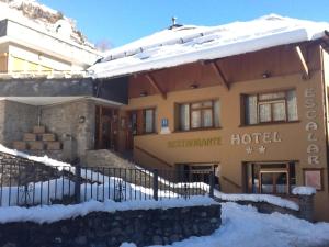 a hotel with snow in front of a building at Hotel Escalar in Panticosa