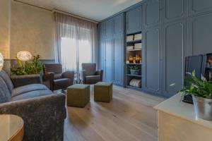 a living room with blue cabinets and a couch at Spazio Duomo1 by Welc(H)ome in Treviso