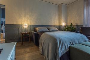 a bedroom with a large bed and a couch at Spazio Duomo1 by Welc(H)ome in Treviso