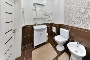 a bathroom with a toilet and a sink at Apartments 144- Expo, Mega Silky Way in Astana +16 photos
