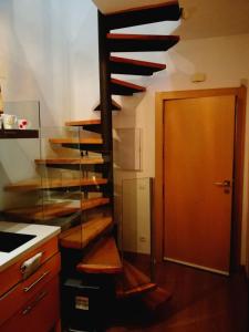 a wooden spiral staircase in a kitchen with a door at Aire in Sierra Nevada