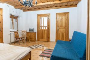a bedroom with a bed and a table and a chair at Rácz Fogadó in Kisoroszi