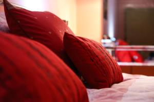 a red pillow sitting on top of a bed at Luxury Brasov in Braşov