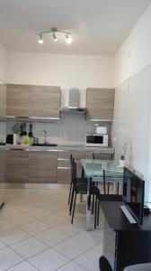 a kitchen with a table and some chairs in a room at Beva Fiera Bologna in Bologna