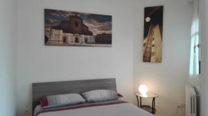 a bedroom with a bed and a painting on the wall at Beva Fiera Bologna in Bologna