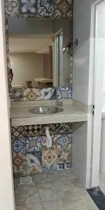 a bathroom with a sink and a mirror at Hostel Trem de Minas in Belo Horizonte