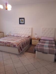 a bedroom with two beds in a room at Jean Home in Gallarate