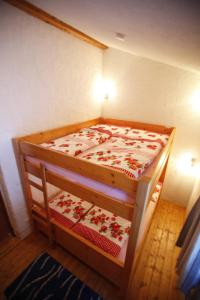 a small bedroom with a wooden bed with flowers on it at Kesslerhütte in Schladming