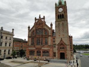 a large brick building with a clock tower on it at Tri ard house Derry city centre STILL OPEN in Derry Londonderry