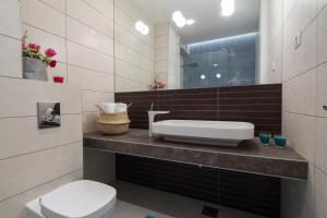 a bathroom with a sink and a toilet at Apartments Blue Maris Žnjan in Split