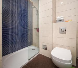 a bathroom with a toilet and a shower at Apartments Blue Maris Žnjan in Split