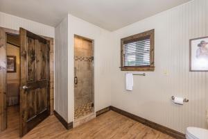 a room with a wooden floor and a large mirror on the wall at Vineyard Trail Cottages- Adults Only in Fredericksburg