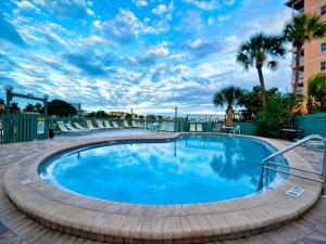 a large swimming pool with a brick walkway around it at Dockside Condos 602 Waterfront Condo 437 in Clearwater Beach