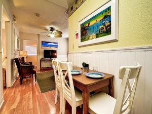 a dining room with a wooden table and chairs at Palm Place 3 - Buccaneer Palm Beach getaway 622 in Clearwater Beach