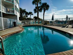 a swimming pool with blue water in a resort at West Coast Vista 3E Bay View Condo 442 in Clearwater Beach