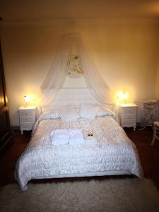 a bedroom with a large bed with two night stands at Il Nido della Formica in Colonnata