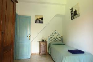 a bedroom with a bed and a stair case at Villette Oasi in San Teodoro
