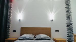 a bedroom with a bed with two lights on the wall at Catalans in Marseille