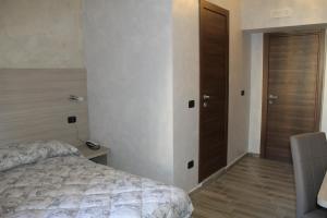 Postel nebo postele na pokoji v ubytování Ricci Rooms