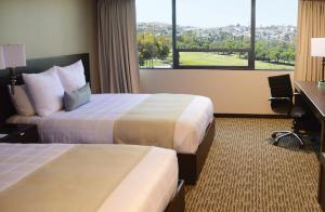 Postel nebo postele na pokoji v ubytování Grand Hotel Tijuana