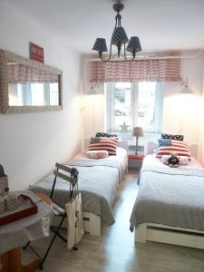a room with three beds and a mirror at Mini Apartament MARINE in Świnoujście
