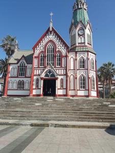 a large building with a clock tower and stairs at Departamento Central in Arica