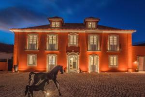 a horse standing in front of a building at Paço do Bispo Boutique House in Sintra