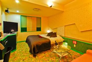 A bed or beds in a room at Hotel Joy (Love Hotel)