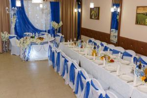 a set of tables with blue and white chairs at VinoGraD HOTEL in Balakovo