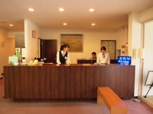 two women are standing at a reception desk at Hotel Innoshima in Onomichi +40 photos