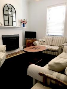 a living room with a couch and a fireplace at 99 Hill Street Apartments in Orange