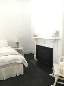 a bedroom with a bed and a dresser at 99 Hill Street Apartments in Orange