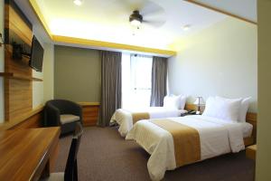 Postel nebo postele na pokoji v ubytování Grand Sierra Pines Baguio