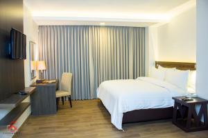 Ένα ή περισσότερα κρεβάτια σε δωμάτιο στο Hotel Marciano