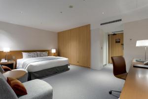 a hotel room with a bed and a couch at Keio Plaza Hotel Tokyo in Tokyo