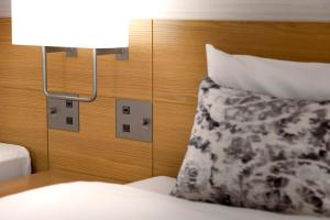 a bedroom with a bed with a pillow and a lamp at Keio Plaza Hotel Tokyo in Tokyo