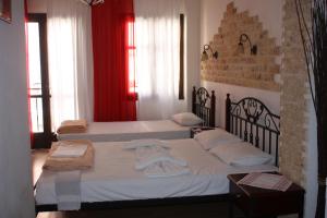 a bedroom with two beds with towels on them at MmeBassia in Chania Town