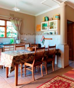 a kitchen with a table and chairs in a room at Petra's Country Guesthouse in Vryheid +23 photos