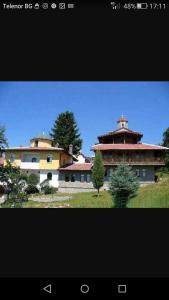a large building with a tower on top of a field at Apartment Diana in Resilovo