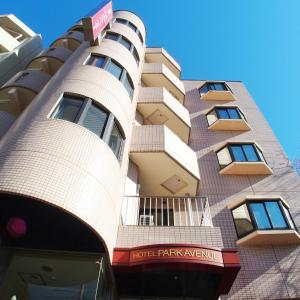 a building with balconies on the side of it at Hotel Park Avenue in Tokyo