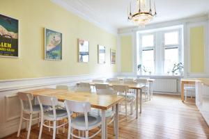 a dining room with tables and chairs and a chandelier at Hotel Hornsgatan in Stockholm