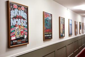 a row of framed movie posters on a wall at Hotel Hornsgatan in Stockholm